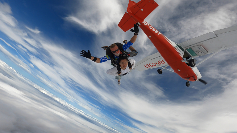Tandem skydiving celebration - Happy jumper after completing first skydive